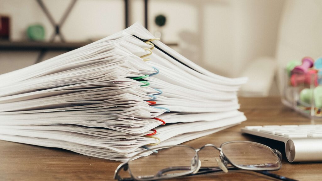 Pile of paper-clipped documents on table