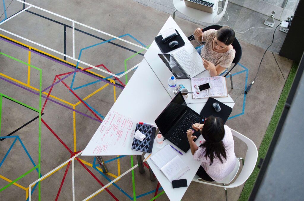 Two women working together or collaborating