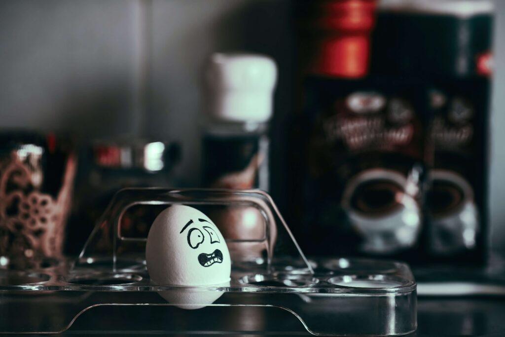 A chicken egg with a drawn emotional egg expressing horror and frustration