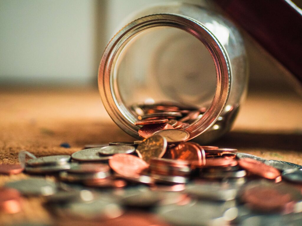 Coins spilling out from jar