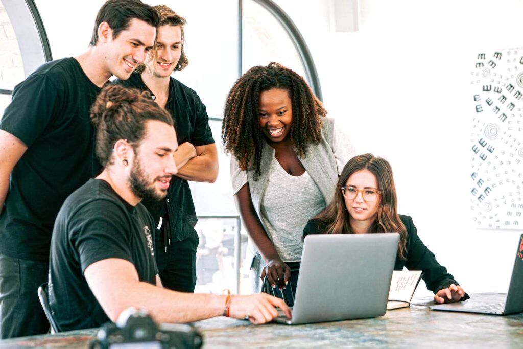 Group of people looking at a laptop