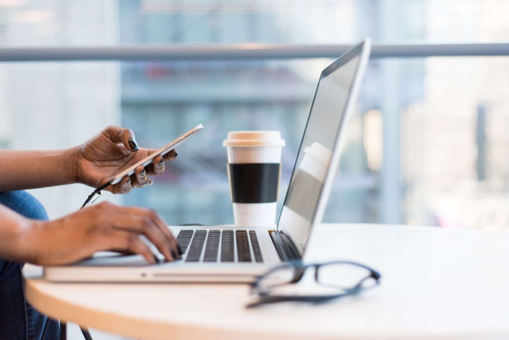 laptop and smartphone with coffee on a table