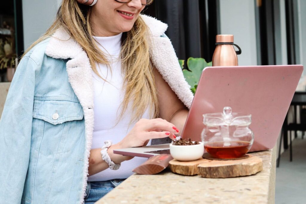 Woman using pink laptop