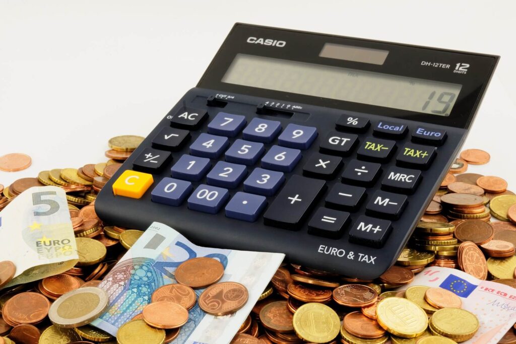 Calculator on top of coins and paper bills