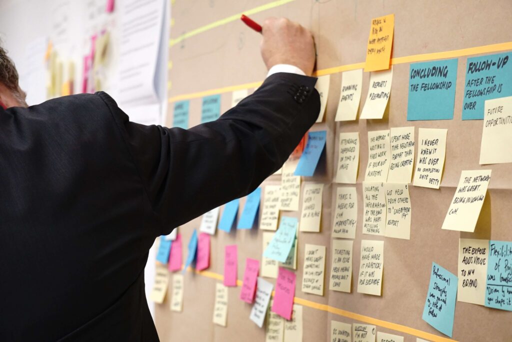 man with stickie notes board