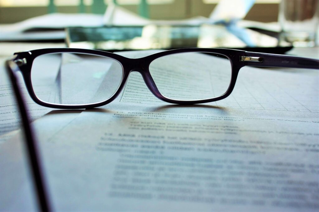 Reading glasses on top of a contract