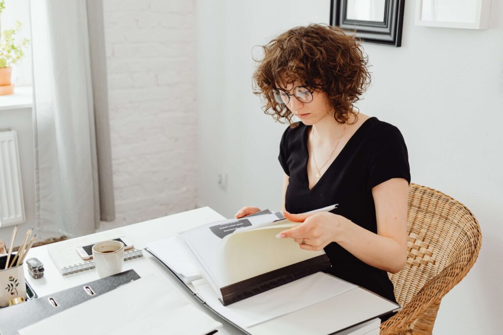 sitting woman checking on files