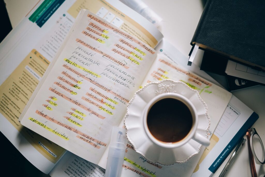 coffee on top of notebook with language notes