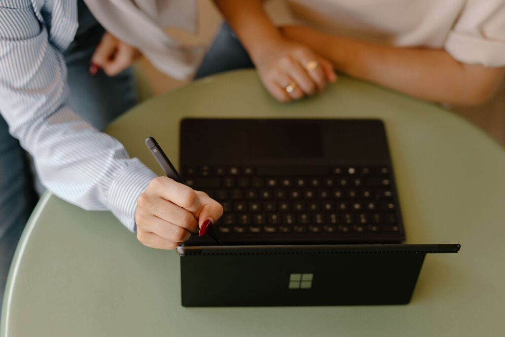 tablet with keyboard, hand holding stylus