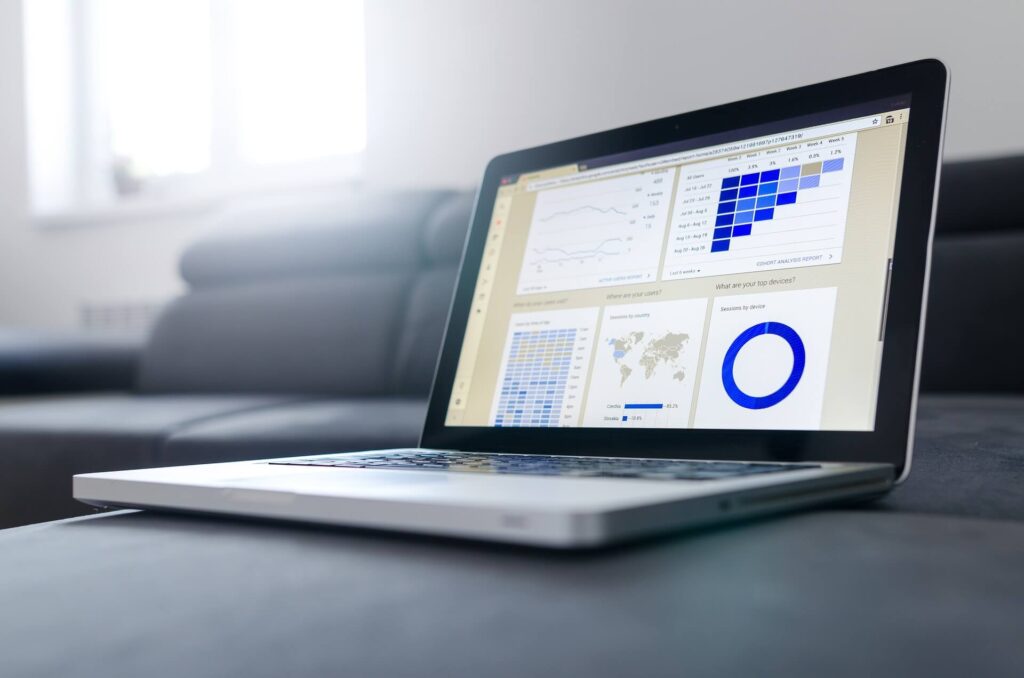 laptop showing graphs, charts and map