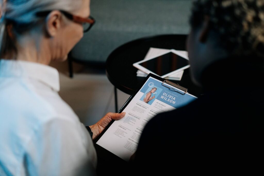 Woman with glasses looking at a resume of an Olivia Wilson