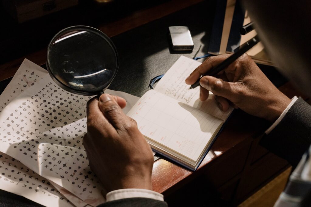 man figuring out a cipher using magnifying glass