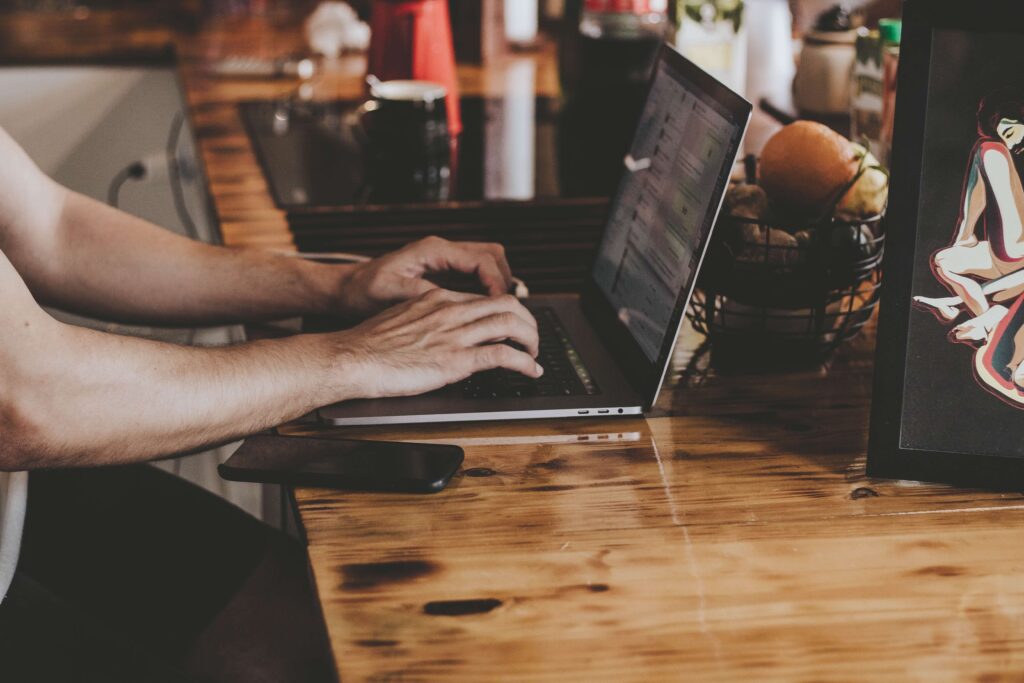 freelancer using laptop on a kitchen counter