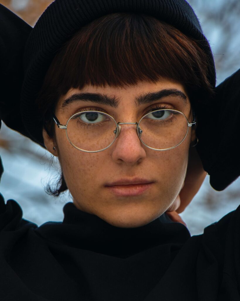 close up of woman wearing glasses and black shirt