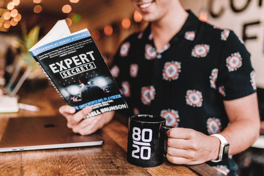 man reading a book about expert secrets