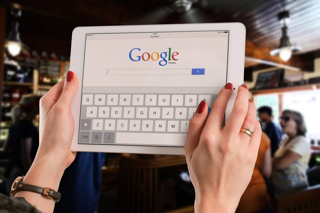 woman's hand holding a tablet