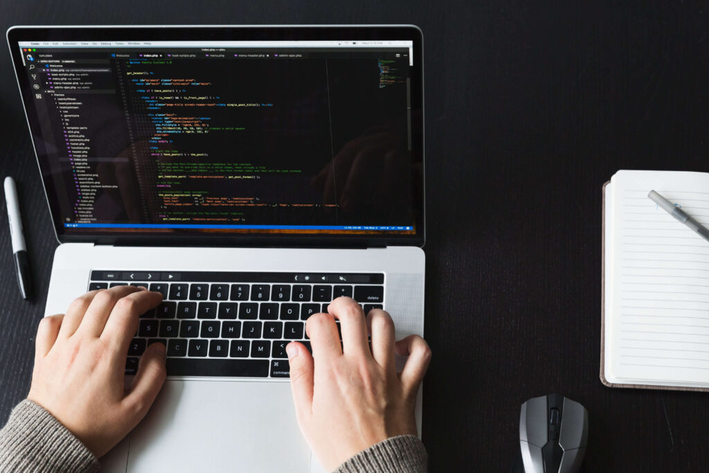 person doing coding on a laptop