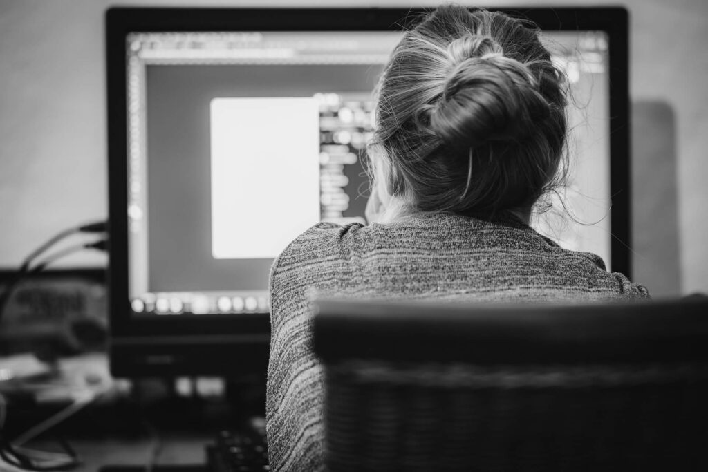 Woman facing a computer monitor