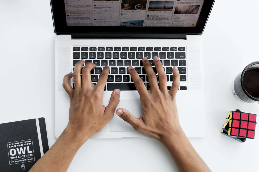 person posting on social media on laptop