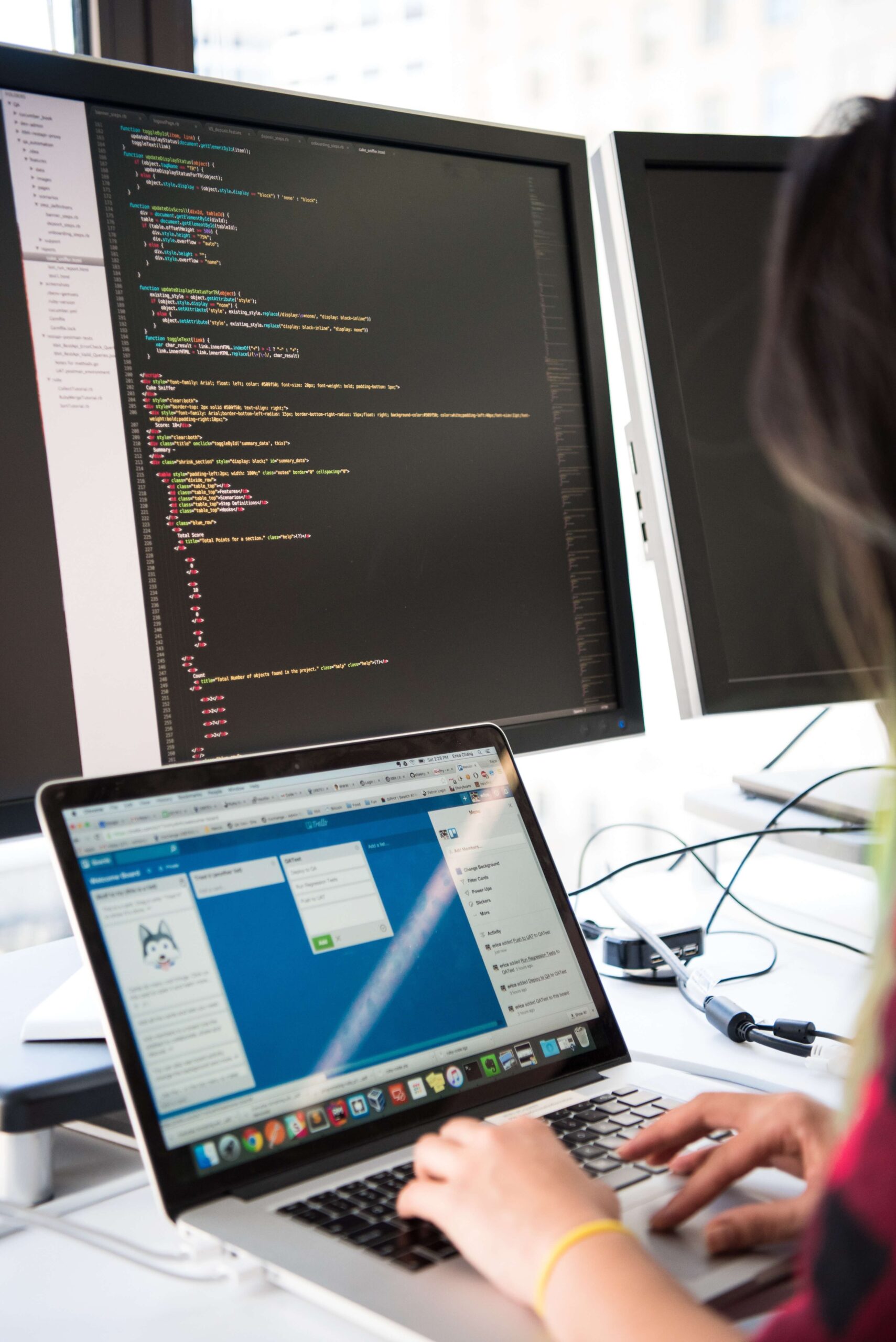 coding seen on computer and woman working on laptop