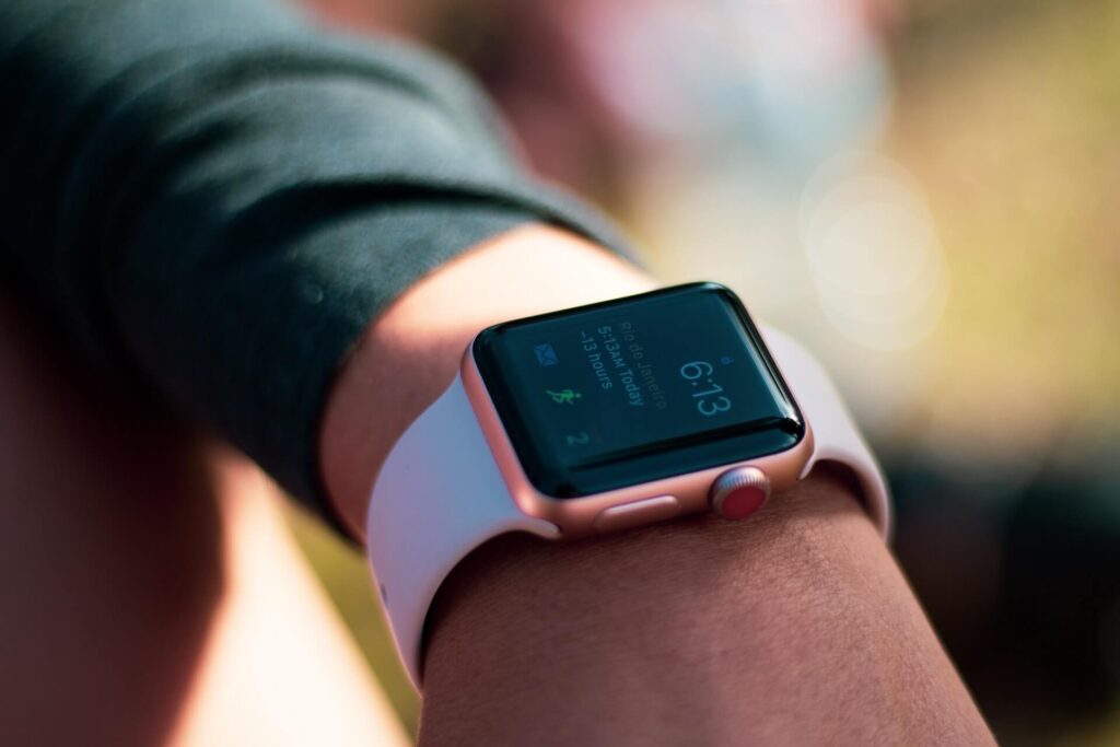 An Apple watch on a wrist showing 6:13
