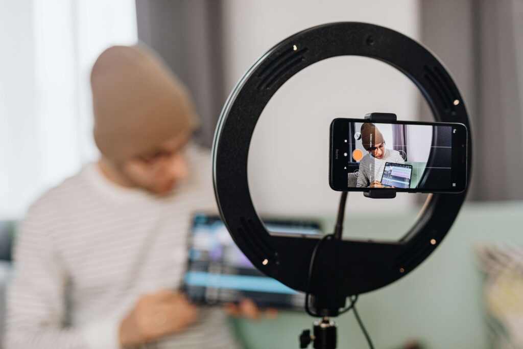 man recording a video of himself showing a tablet