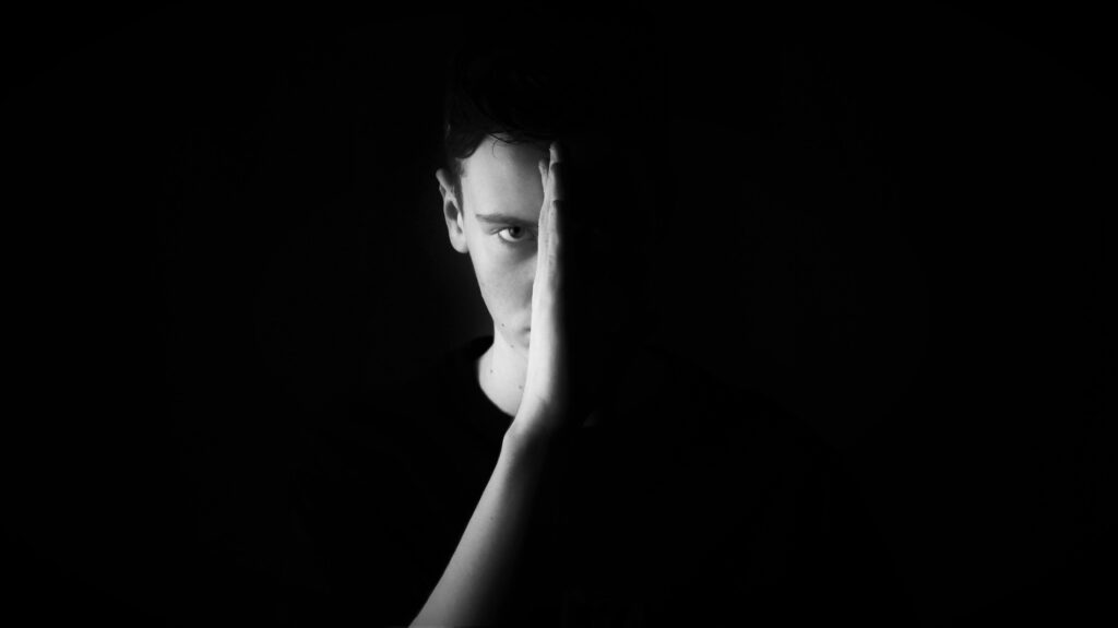 black and white photo of man showing half of face