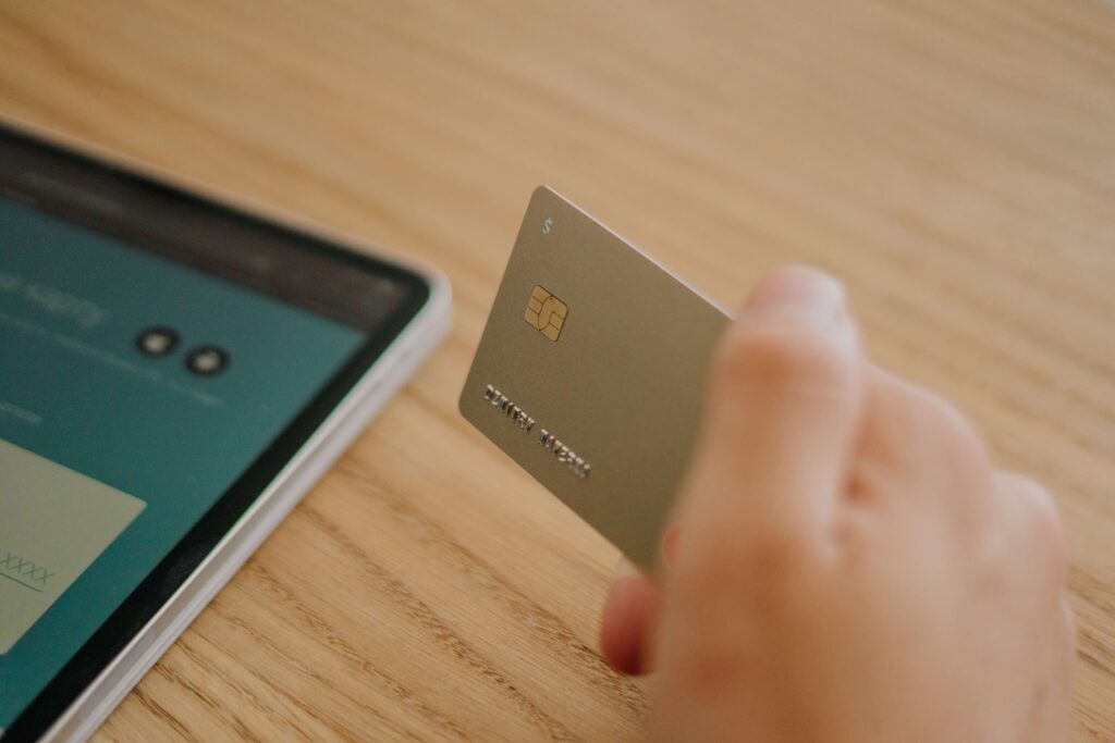 close up of a hand holding a credit card