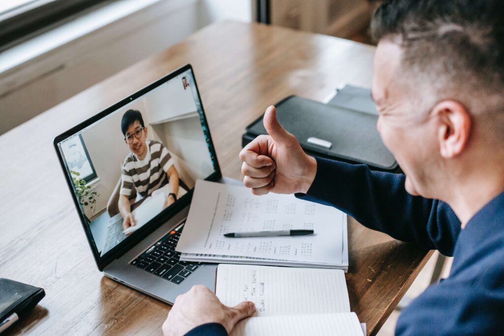 man giving thumbs while up on video conference with another man